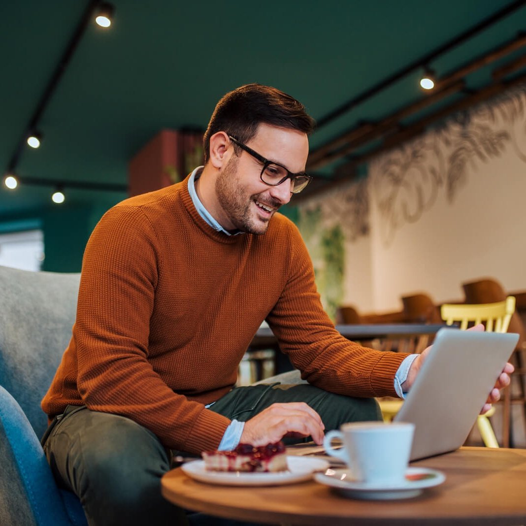 Home cheerful man using laptop in a cozy restaurant po 2024 10 18 07 51 26 utc 1 1 cropped.jpg